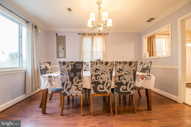 dining room with ornamental molding, a wealth of natural light, and dark hardwood / wood-style floors