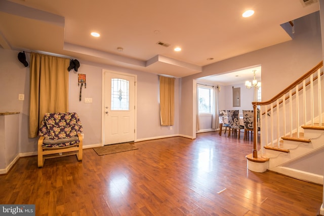 foyer featuring a chandelier and dark hardwood / wood-style flooring