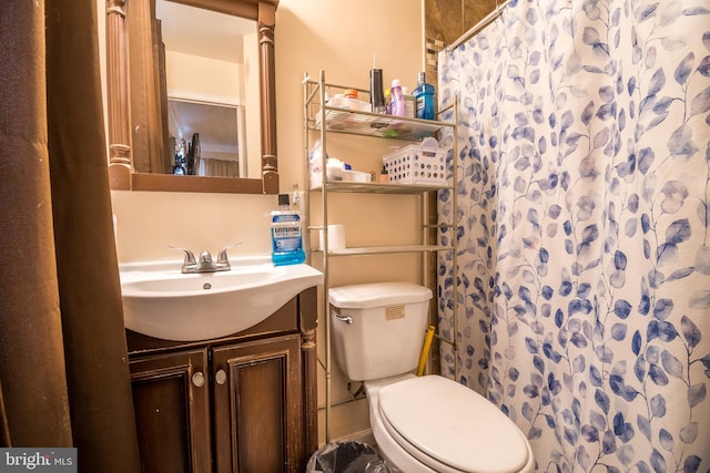 bathroom featuring toilet, a shower with curtain, and vanity