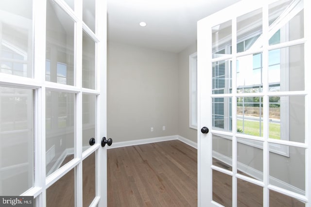 unfurnished room with french doors and hardwood / wood-style flooring