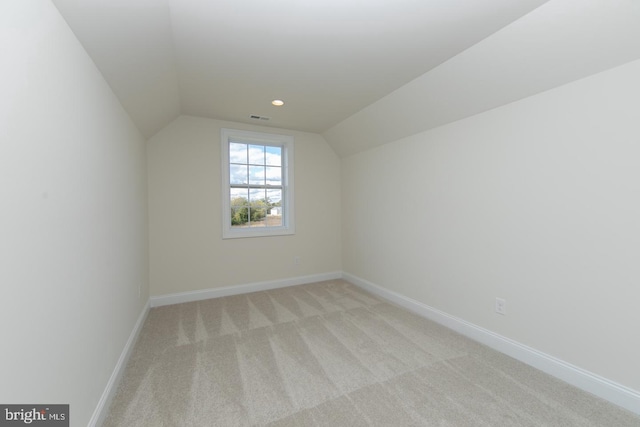 bonus room featuring lofted ceiling and light carpet