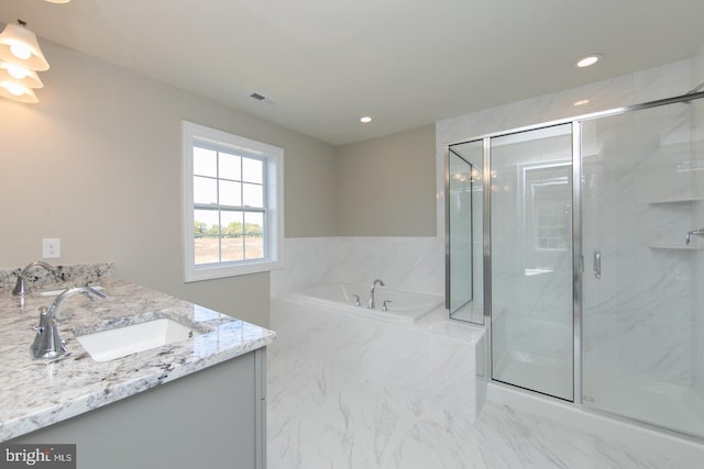 bathroom featuring vanity and shower with separate bathtub