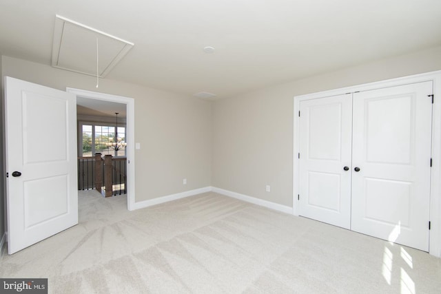 unfurnished bedroom with light carpet and a closet