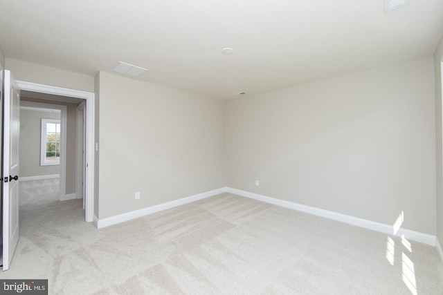 empty room with light colored carpet