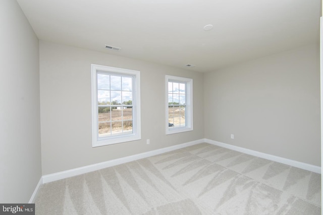 unfurnished room with light carpet