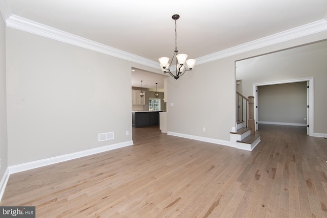 unfurnished dining area with wood-type flooring, an inviting chandelier, and ornamental molding