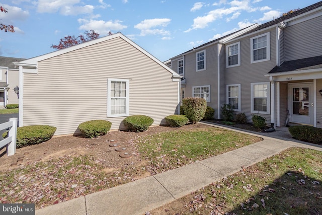 view of property exterior with a yard