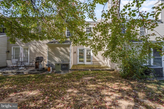 rear view of house featuring central AC and a patio area