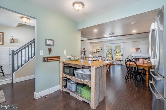 kitchen with butcher block countertops, stainless steel fridge, and dark wood-type flooring