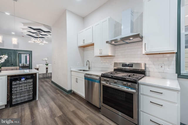 kitchen featuring wall chimney range hood, white cabinets, beverage cooler, appliances with stainless steel finishes, and dark hardwood / wood-style floors