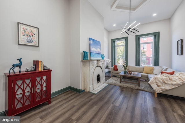 living room featuring dark hardwood / wood-style flooring and a chandelier