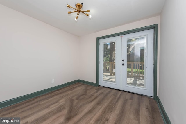 empty room featuring french doors and dark hardwood / wood-style flooring