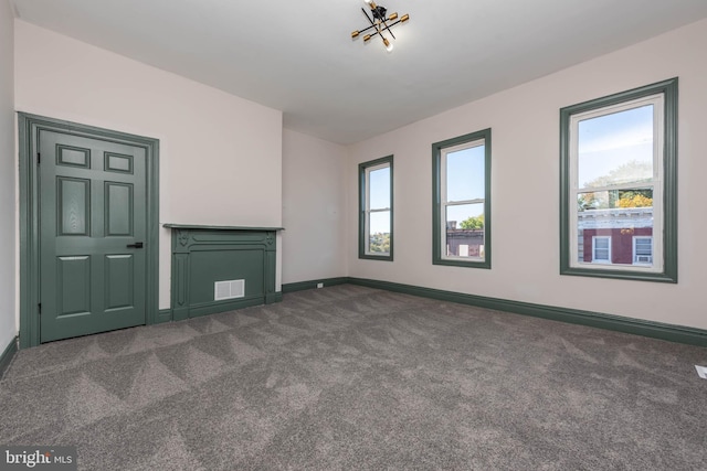 unfurnished living room with dark carpet