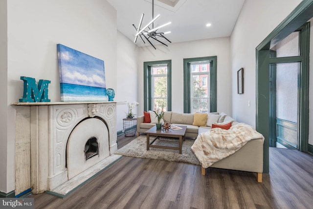 living room with a chandelier and dark hardwood / wood-style floors