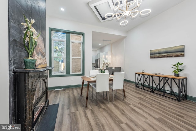 dining area featuring an inviting chandelier and hardwood / wood-style flooring