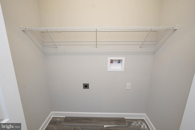 washroom with hookup for an electric dryer, dark wood-type flooring, and hookup for a washing machine