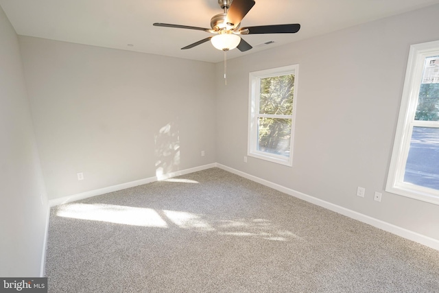 carpeted spare room with ceiling fan