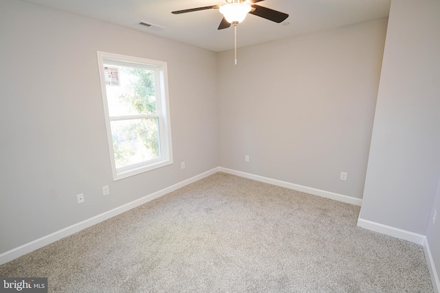 empty room with ceiling fan and carpet