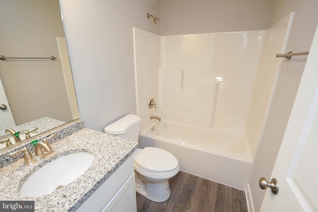 full bathroom with toilet, shower / washtub combination, hardwood / wood-style floors, and vanity