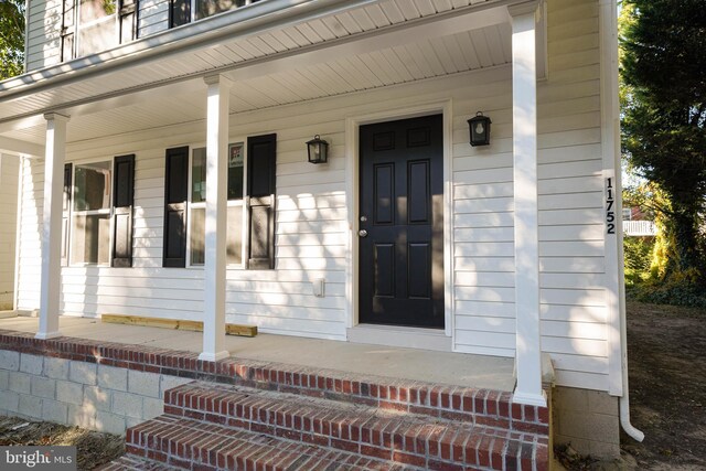 view of exterior entry featuring a porch