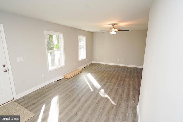 empty room with hardwood / wood-style flooring and ceiling fan