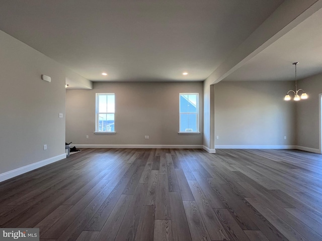 unfurnished room featuring recessed lighting, baseboards, a chandelier, and dark wood-style flooring