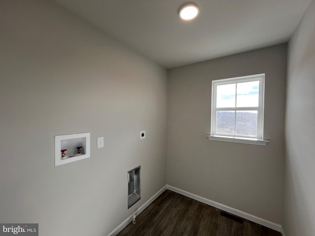 laundry area featuring dark wood-type flooring, baseboards, laundry area, hookup for a washing machine, and hookup for an electric dryer