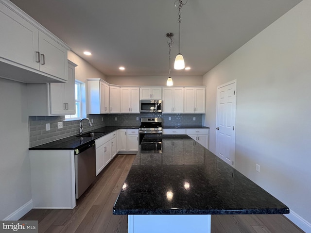 kitchen featuring a sink, white cabinets, tasteful backsplash, and stainless steel appliances