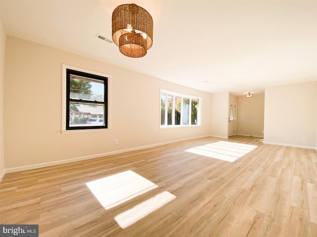 empty room with plenty of natural light and light wood-type flooring