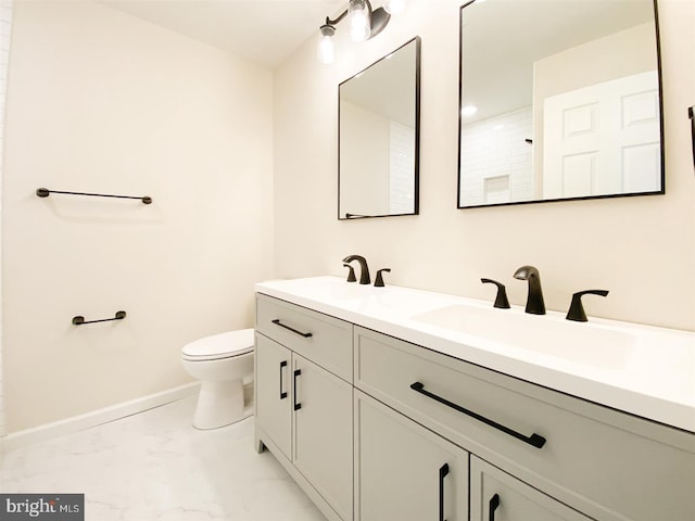 bathroom featuring vanity, toilet, and walk in shower