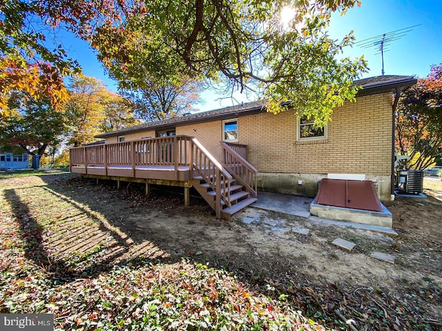 rear view of property with a deck and central air condition unit