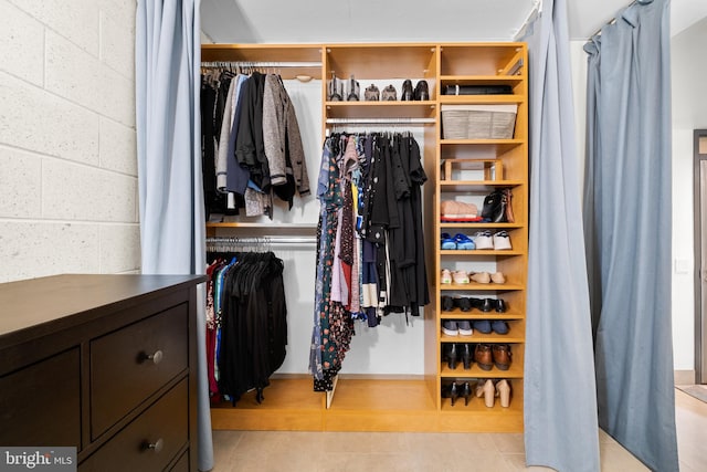 spacious closet featuring light tile patterned flooring