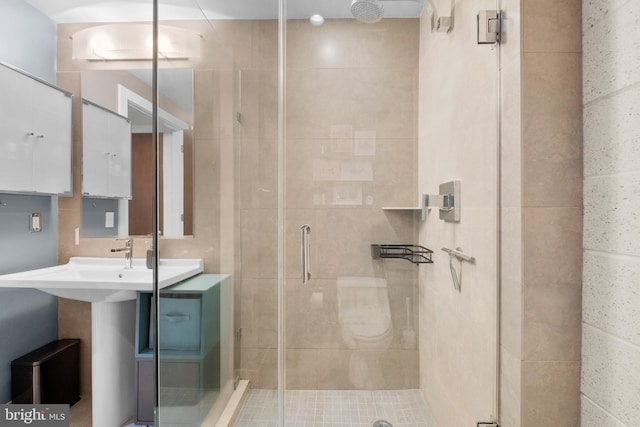 bathroom with a shower with shower door