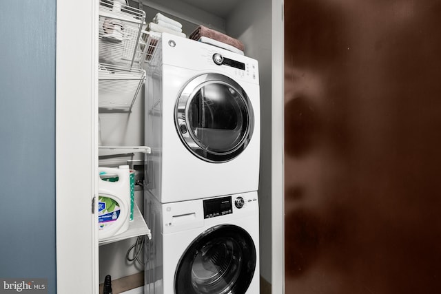 laundry area with stacked washer and clothes dryer