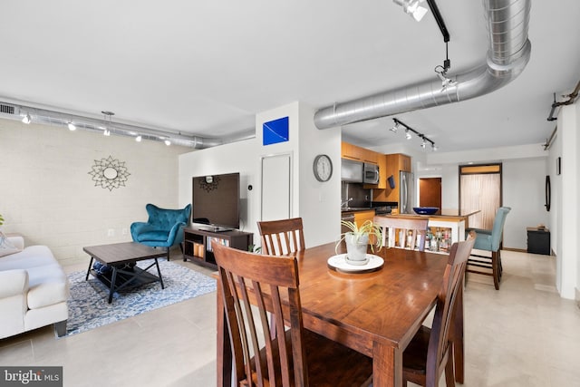 dining space featuring track lighting