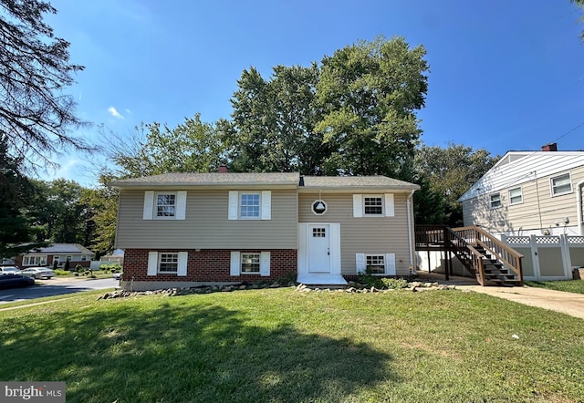 split foyer home with a front lawn