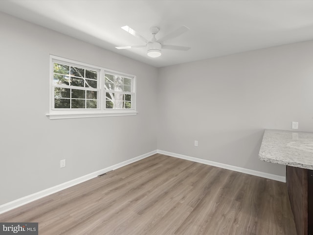 empty room featuring hardwood / wood-style flooring and ceiling fan