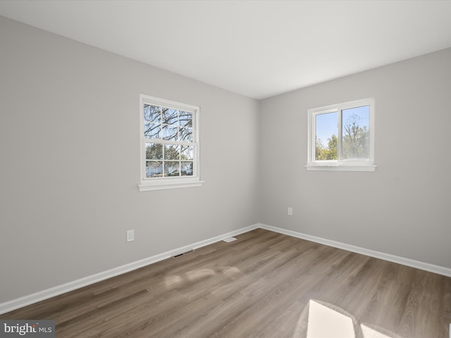 spare room featuring hardwood / wood-style flooring