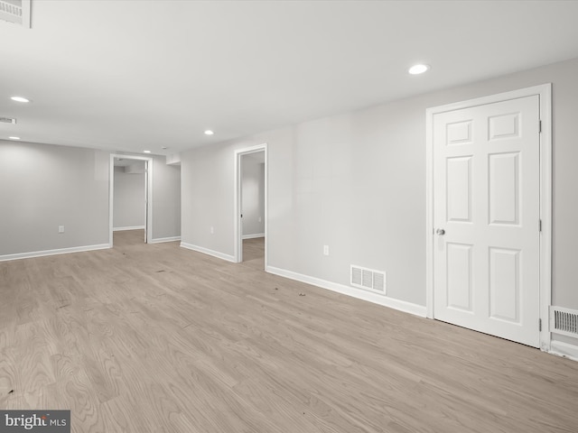 basement with light hardwood / wood-style floors