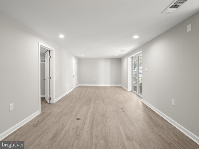 empty room with light hardwood / wood-style floors