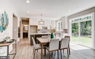 dining space with light hardwood / wood-style flooring