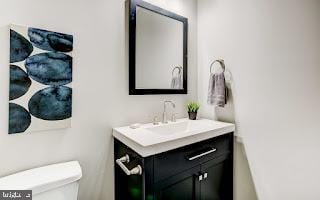 bathroom featuring vanity and toilet