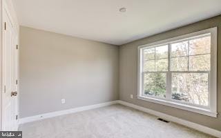 unfurnished room featuring light colored carpet