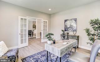 home office featuring hardwood / wood-style floors and french doors