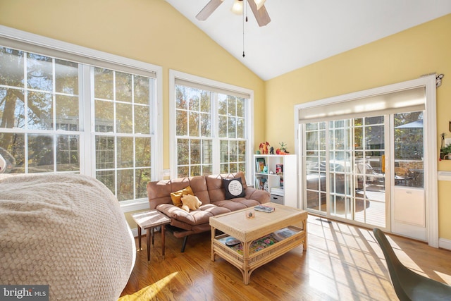 sunroom with ceiling fan and vaulted ceiling