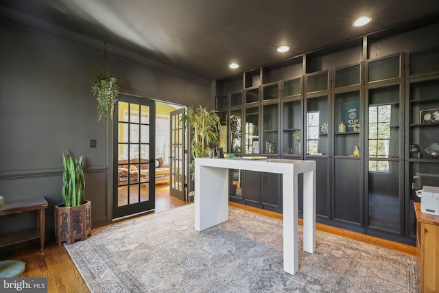 office space with french doors, hardwood / wood-style floors, a healthy amount of sunlight, and crown molding