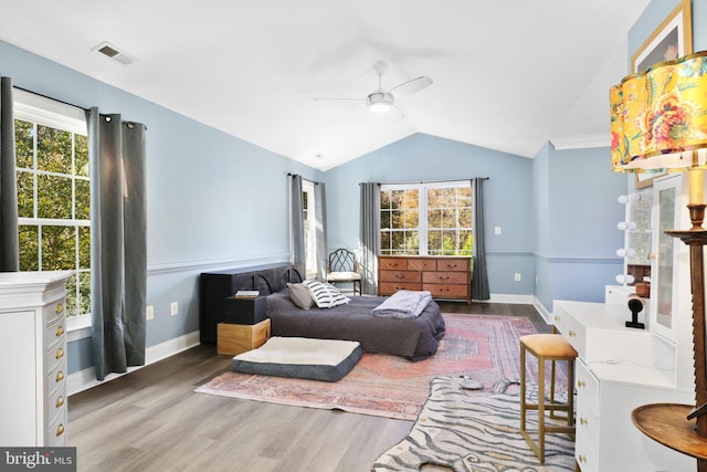 bedroom with dark wood-type flooring, vaulted ceiling, and ceiling fan