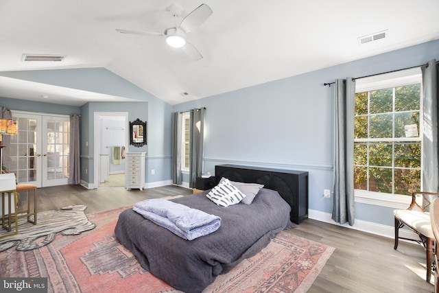 bedroom with french doors, ceiling fan, wood-type flooring, and lofted ceiling