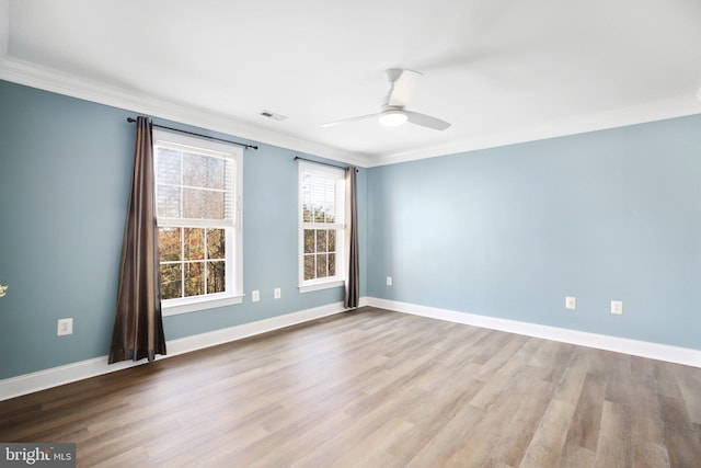 empty room with crown molding, light hardwood / wood-style floors, and ceiling fan