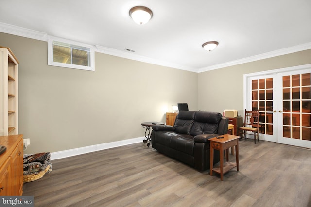 living room featuring french doors, hardwood / wood-style flooring, and crown molding